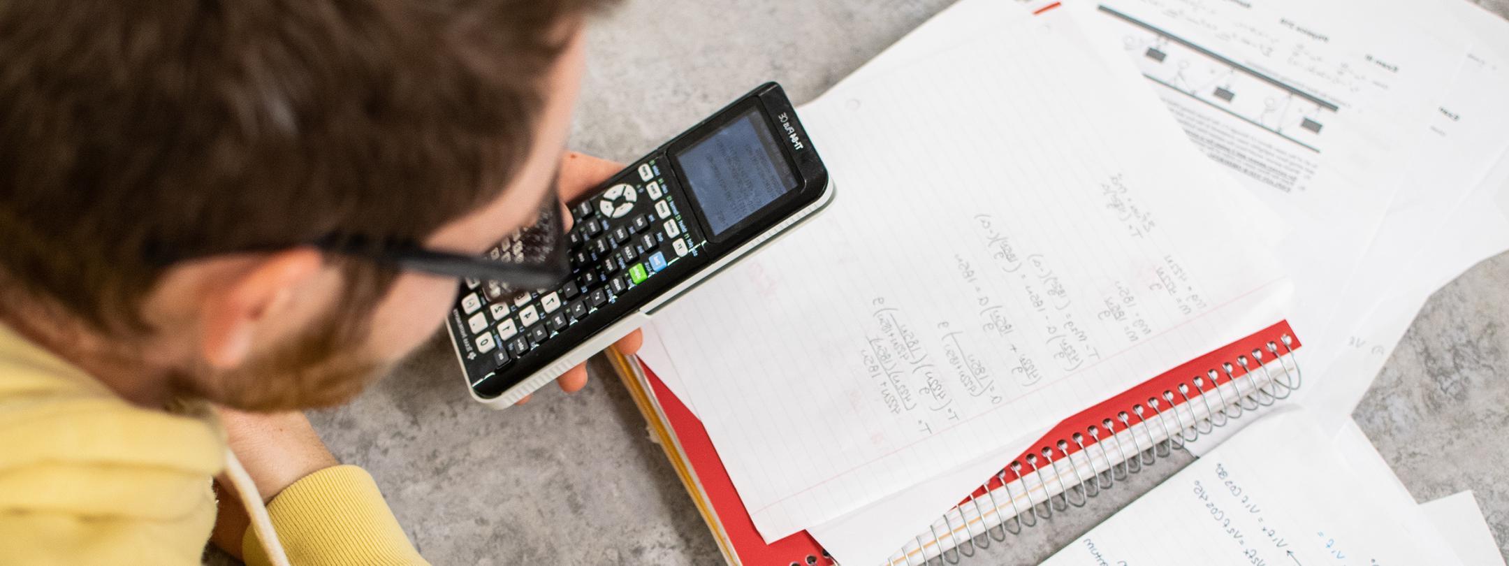 A student with a calculator